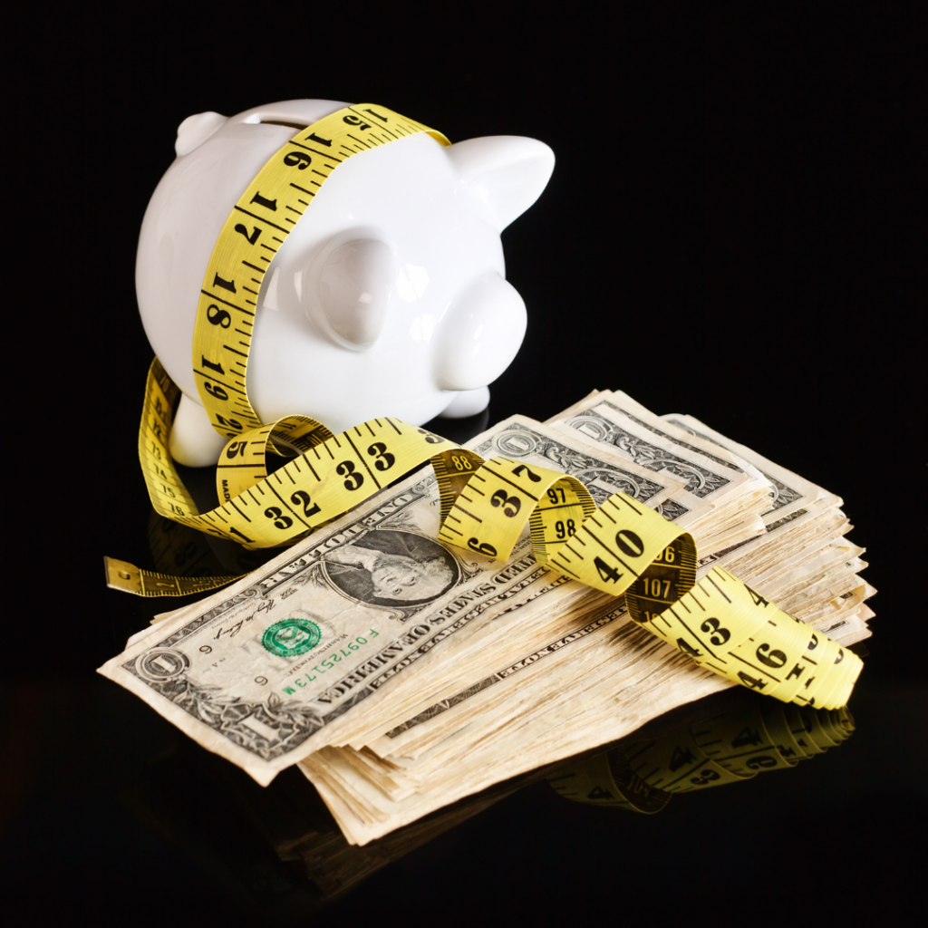 Image of a piggy bank, money and a measuring tape, symbolising measurement of success